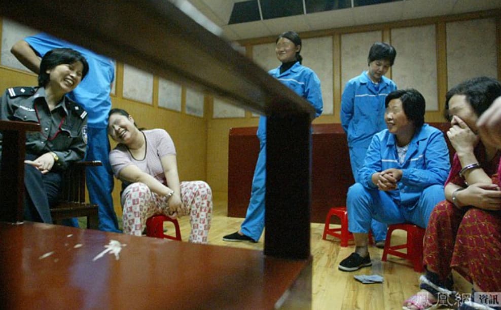 Chinese death row inmate He Xiuling shares a laugh with a guard and fellow inmates hours before her execution. 